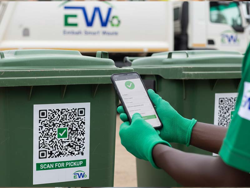 Worker scanning QR code on dustbin for verified collection